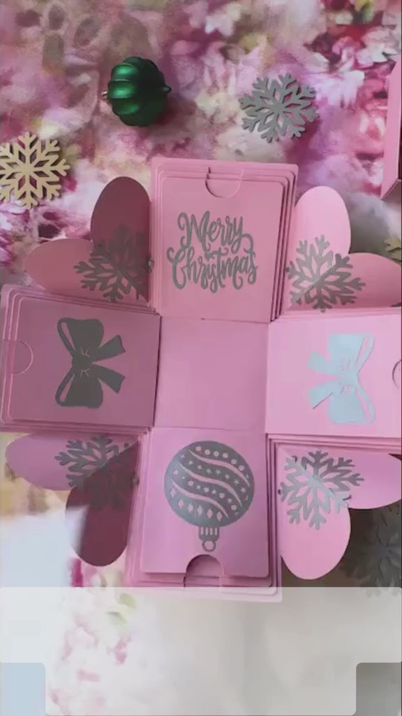 Product demo video of pink Christmas explosion gift box showing unboxing, layers opening, and inserts displayed.