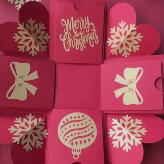 Red Christmas explosion gift box unboxing video showing photo layers and holiday surprise.