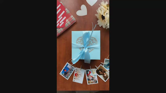 Video showing a black and red explosion gift box unfolding layer by layer, revealing photos, pull-out albums, and heartfelt message cards. The product demo highlights its customizable design and elegant craftsmanship, perfect for birthdays, anniversaries, and romantic gifting.
