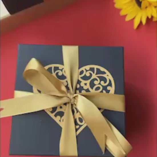 Elegant black and gold anniversary explosion gift box opening to reveal romantic photos, love notes, and pull-out albums. The luxurious design and metallic accents make it a perfect personalized keepsake for celebrating lasting love.