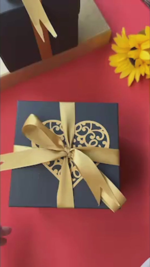 Elegant black and gold anniversary explosion gift box opening to reveal romantic photos, love notes, and pull-out albums. The luxurious design and metallic accents make it a perfect personalized keepsake for celebrating lasting love.